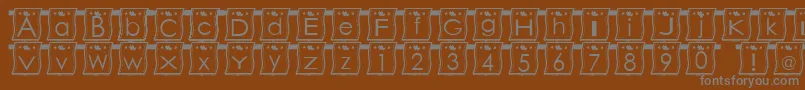 WlFont-fontti – harmaat kirjasimet ruskealla taustalla