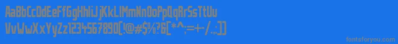 フォントStahlbetontraegerCompressed – 青い背景に灰色の文字