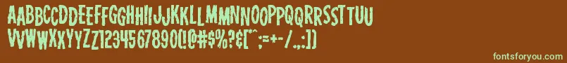 フォントCarnivalcorpsestag – 緑色の文字が茶色の背景にあります。