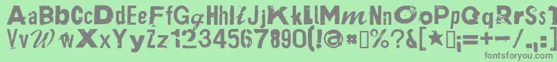 PlakkenRegular-fontti – harmaat kirjasimet vihreällä taustalla