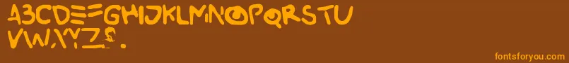 フォントBuried – オレンジ色の文字が茶色の背景にあります。