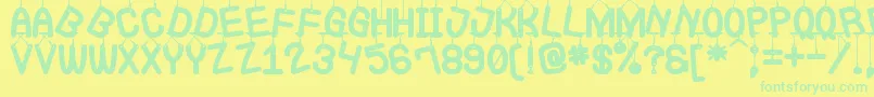 フォントLaQueCuelgaSt – 黄色い背景に緑の文字