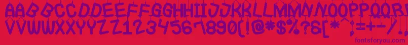 フォントLaQueCuelgaSt – 赤い背景に紫のフォント