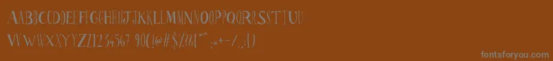 Ppscrabionau-Schriftart – Graue Schriften auf braunem Hintergrund