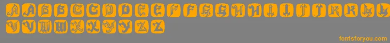 Hauntedbricks-Schriftart – Orangefarbene Schriften auf grauem Hintergrund