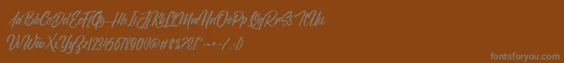 NovithaScriptDemo-Schriftart – Graue Schriften auf braunem Hintergrund