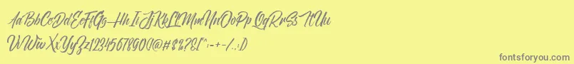 NovithaScriptDemo-Schriftart – Graue Schriften auf gelbem Hintergrund
