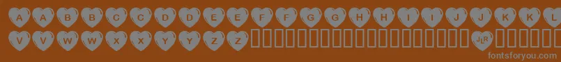 JlrSimpleHearts Font – Gray Fonts on Brown Background