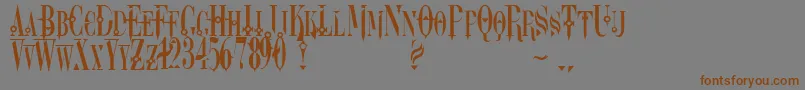 フォントDreamscar – 茶色の文字が灰色の背景にあります。