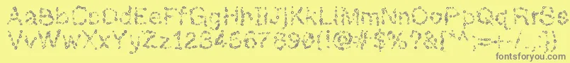フォントAlmostinfinity – 黄色の背景に灰色の文字