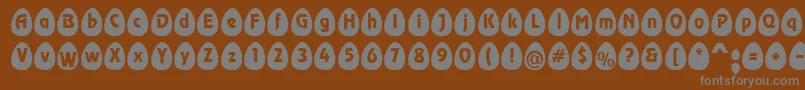 EggsblackBecker-fontti – harmaat kirjasimet ruskealla taustalla