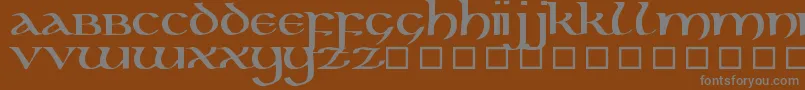 KellsUncialBold-fontti – harmaat kirjasimet ruskealla taustalla