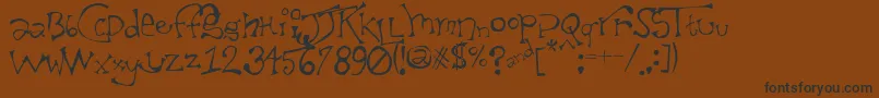 TaxidermistIi Font – Black Fonts on Brown Background