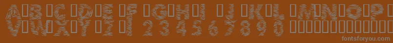 101ZebraPrint-fontti – harmaat kirjasimet ruskealla taustalla