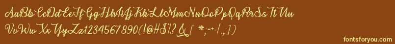 SnowflakeCalligraphyTtf-fontti – keltaiset fontit ruskealla taustalla