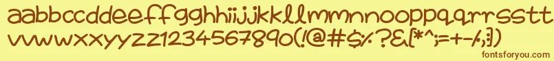フォントFairiesAreReal – 茶色の文字が黄色の背景にあります。