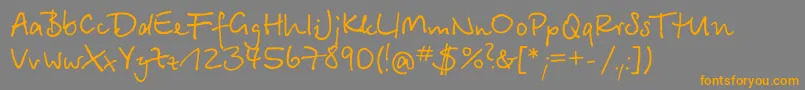 フォントBetinascriptcttRegular – オレンジの文字は灰色の背景にあります。