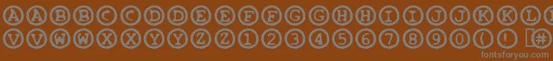 OleeosFartzake-fontti – harmaat kirjasimet ruskealla taustalla