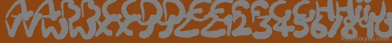 Squiggler-fontti – harmaat kirjasimet ruskealla taustalla