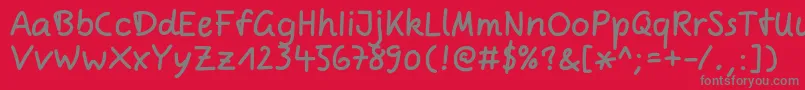 ComicjensRegular-Schriftart – Graue Schriften auf rotem Hintergrund