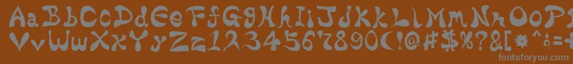 BharaticFontV15-fontti – harmaat kirjasimet ruskealla taustalla