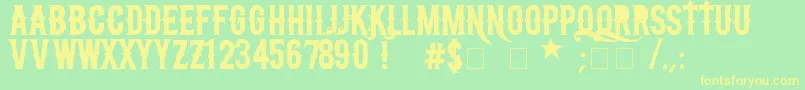 フォントNFcCreactivo2008 – 黄色の文字が緑の背景にあります