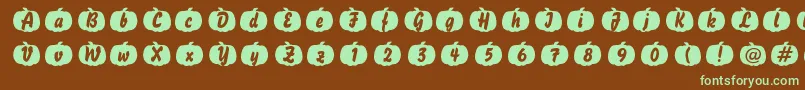 フォントPumpkinese – 緑色の文字が茶色の背景にあります。