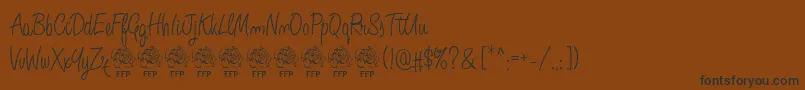 AngeliqueRoseFontFfp-Schriftart – Schwarze Schriften auf braunem Hintergrund
