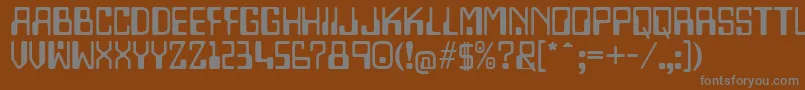 Lazenbycompliquid-fontti – harmaat kirjasimet ruskealla taustalla