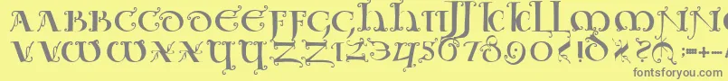Uncialeornamentale-fontti – harmaat kirjasimet keltaisella taustalla