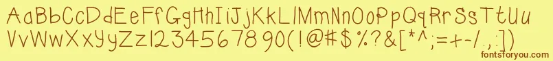 フォントKbsunshinebold – 茶色の文字が黄色の背景にあります。