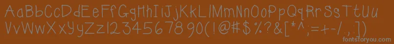 Kbsunshinebold-fontti – harmaat kirjasimet ruskealla taustalla