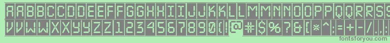 ALcdnovacmfr-fontti – harmaat kirjasimet vihreällä taustalla
