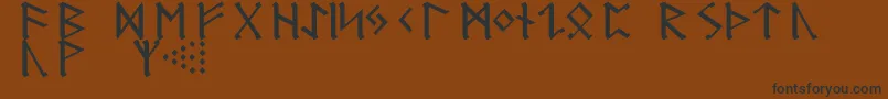 フォントGermanicRunes – 黒い文字が茶色の背景にあります