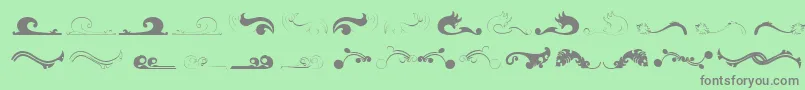 Felicity-fontti – harmaat kirjasimet vihreällä taustalla
