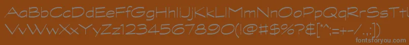 GraphitestdLightwide-fontti – harmaat kirjasimet ruskealla taustalla