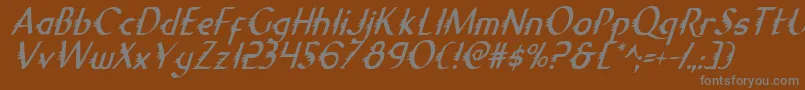 GypsyRoadCondensedItalic-fontti – harmaat kirjasimet ruskealla taustalla