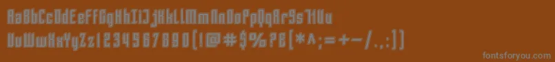 SfPiezolectricInline-fontti – harmaat kirjasimet ruskealla taustalla