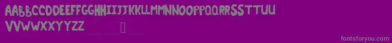 Terminant-fontti – harmaat kirjasimet violetilla taustalla