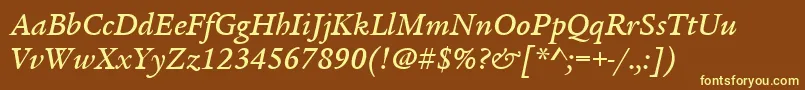 ItcLegacySerifLtMediumItalic-fontti – keltaiset fontit ruskealla taustalla