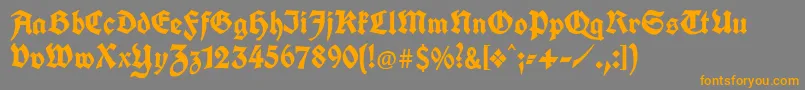 フォントUnifrakturcook – オレンジの文字は灰色の背景にあります。