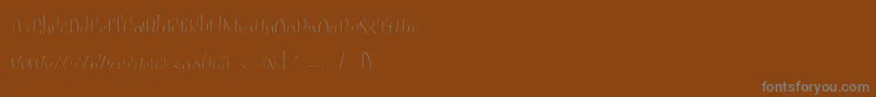 Sudegnakno3c-Schriftart – Graue Schriften auf braunem Hintergrund