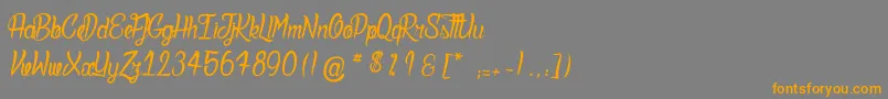 フォントDeadlyInked – オレンジの文字は灰色の背景にあります。