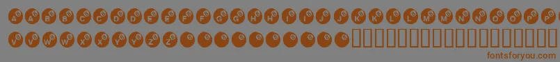 フォントKrEightBall – 茶色の文字が灰色の背景にあります。