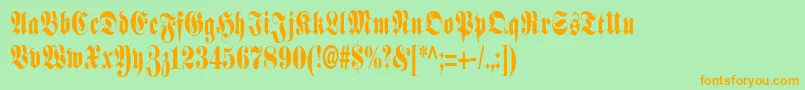 フォントSchmalfetteFraktur – オレンジの文字が緑の背景にあります。