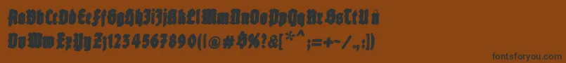 フォントFatfreefrax – 黒い文字が茶色の背景にあります