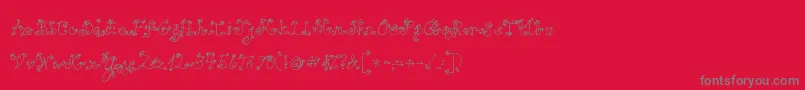 Fonte Jandaloveandrain – fontes cinzas em um fundo vermelho