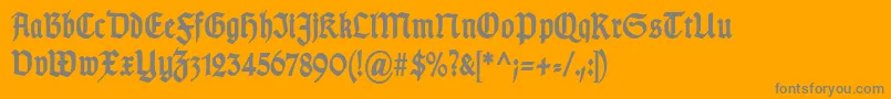 TypographergotischSchmalBold-Schriftart – Graue Schriften auf orangefarbenem Hintergrund