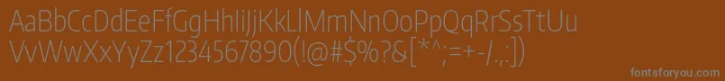 フォントEncodesanscompressedExtralight – 茶色の背景に灰色の文字