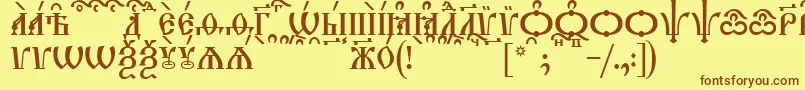 TriodionCapsKucs Font – Brown Fonts on Yellow Background